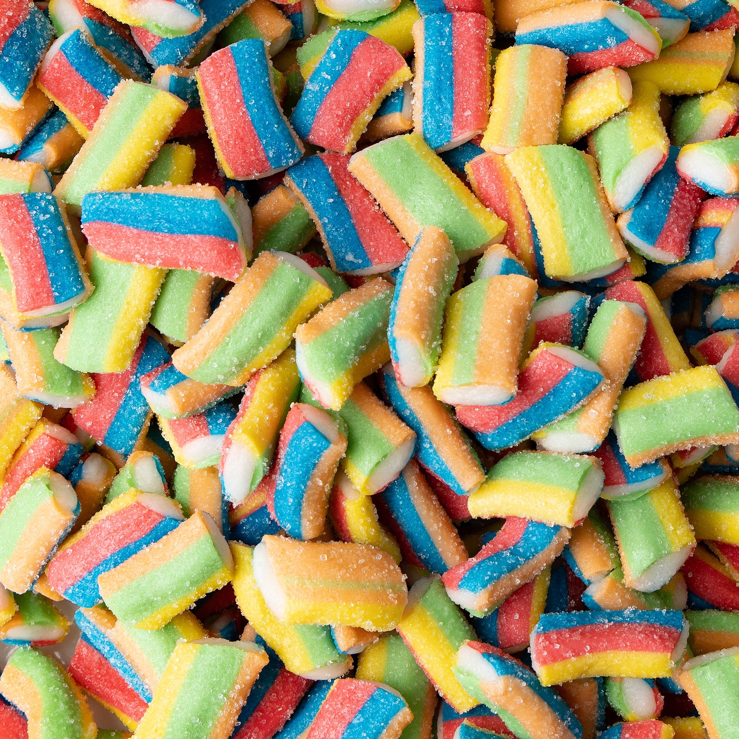Colorful chewy candies shaped like small ropes, featuring stripes of blue, red, yellow, and green, shown in a pile.